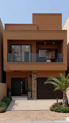 a modern house with two garages and palm trees