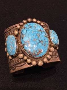 "Santo Domingo/Kewa Pueblo artist, Maynard Garcia's fine natural Kingman \"Water Web Bird's Eye\" turquoise & heavy gauge sterling silver wide cuff... 3 multi stone... Native American made... Fine! Lovely stamp work! Gorgeous! Stamped Maynard Garcia & Sterling 5.75\" interior circumference plus 1 3/16\" gap Stamped wide band is 2.25\" wide, & 2.5\" wide including decorative silver work surrounding main center stone, which is 1.75\" long by 1 5/16\" wide. 494R - This stunning piece is Silver Work, Wide Cuff, Jewelry Choker, Freshwater Pearl Necklaces, Native American Indians, American Jewelry, American Indian, Wide Bands, Multi Stone