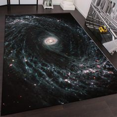 an area rug with a spiral galaxy design on it