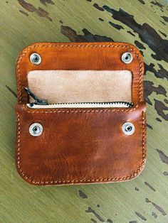 We use natural, eco-friendly, veg-tanned leather. It goes through a process that produces durable, exquisite leathers recognized for their depth of color and rich patina. Conditioned to last, each collar is designed to withstand the test of time and ages beautifully. Saddle Tan mini trucker wallet 100% full grain leather and handmade  Has a zipper compartment for money and credit cards as well as a second hidden compartment for additional cards/money. Approximate dimensions are 3 1/2 x 5 inches Classic Leather Wallet, Vegetable-tanned, Brown Vegetable Tanned Leather Wallets For Everyday Use, Brown Vegetable Tanned Leather Wallet For Everyday Use, Everyday Brown Vegetable-tanned Wallet, Vegetable-tanned Leather Wallet For Daily Use, Brown Vegetable-tanned Leather Wallets For Everyday Use, Brown Vegetable-tanned Trifold Wallet For Daily Use, Vegetable-tanned Leather Wallet, Daily Use Vegetable-tanned Leather Wallet