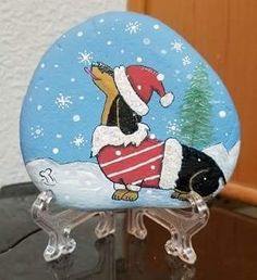 a glass figurine with a dachshund wearing a santa hat and scarf