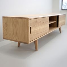 the sideboard is made out of wood and has two drawers