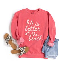 Sunshine, Sand, Sweatshirts? Heck Yeah: Life is Better at the Beach Comfort Colors Sweatshirt Trade in your stress for seashells with this comfy, vintage-washed sweatshirt! Because let's be real, life truly is better at the beach. Why this sweatshirt is your beach bestie: Comfort Colors softness + salty air = pure bliss: This sweatshirt feels like your favorite childhood blanket, with a touch of that fresh ocean breeze. Beach vibes all year round: Who needs palm trees when you can wear your love Pink Cotton Sweatshirt For The Beach, Casual Pink Beach Sweatshirt, Beach Season Sweatshirt With Letter Print, Letter Print Sweatshirt For Beach Vacation, Pink Summer Vacation Sweatshirt, Cotton Sweatshirt For Beach Vacation, Cotton Sweatshirt For Beach Season Vacation, Pink Sweatshirt For Summer Vacation, Cotton Sweatshirt With Letter Print