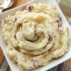 mashed potatoes in a square white dish on a table