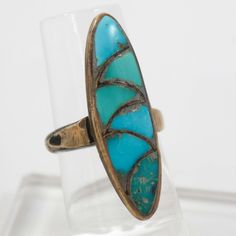 1950s Zuni Sterling Silver Ring with Mosaic Inlaid Natural American Turquoise. Ring Size: 4.75.375” Setting Width, 1.25” Setting Height.125” Band Width Oval Turquoise Inlay Rings, Oval Turquoise Rings With Inlay, Vintage Green Turquoise Ring With Inlay, Collectible Blue Turquoise Inlay Ring, Collectible Multi-stone Turquoise Oval Ring, Vintage Blue Rings With Inlay, Collectible Blue Inlay Rings, Vintage Turquoise Inlay Ring, Antique Turquoise Ring With Patina