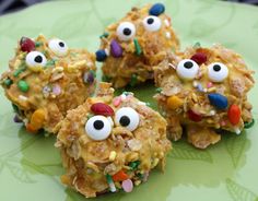 cookies decorated with eyes and candy bars on a green plate