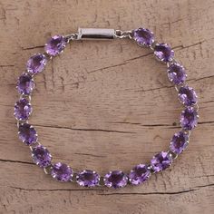 A truly dazzling accessory, this tennis-style bracelet is composed of glittering amethysts totaling 25.5 carats. Artisan Alok Jain of India designs the bracelet with rhodium-plated sterling silver accents. Silver Chandelier Earrings, Tennis Style, Silver Chandelier, Ruby Pendant, Amethyst Color, Sterling Silver Dangle Earrings, Amethyst Bracelet, Strand Bracelet, Sea Glass Jewelry