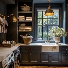 a washer and dryer in a room next to a window with lights on