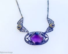 "~ 1920s gorgeous old brass filigree necklace with purple glass ~ Large faceted purple glass stone ~Old wonderful chain, paper clip style ~ Delicate enamel leaves ~ Excellent condition Length- 18\" (45.5 cm) Drop when held- 8.5\" (21.59 cm) More Fantastic Vintage Jewelry: glennasvintageshop.etsy.com Additional Vintage in our sister shop Glenna's Jewels: glennasjewels.etsy.com Instagram @glennas_clothing Facebook https://www.facebook.com/glennasclothing" Vintage Purple Filigree Jewelry, Vintage Purple Jewelry With Intricate Design, Antique Purple Metal Jewelry, Antique Handmade Purple Jewelry, Purple Vintage Jewelry With Intricate Design, Handmade Antique Purple Jewelry, Antique Purple Jewelry With Intricate Design, Vintage Purple Filigree Necklace, Purple Vintage Filigree Necklace