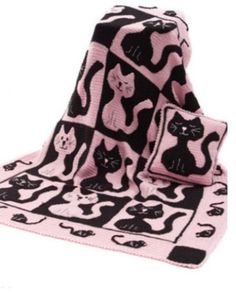 a pink and black cat blanket with matching pillows