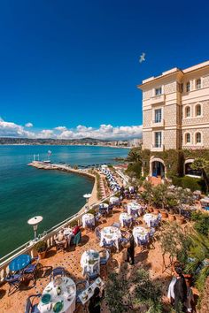 an outdoor dining area overlooking the ocean