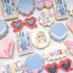 many decorated cookies on a white table with pictures and words in the shape of heart - shaped sunglasses