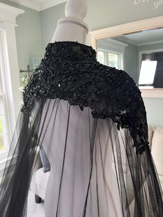 the back of a dress with black lace on it