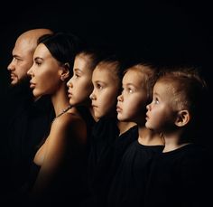 a group of people standing next to each other in front of a black background with the same person's face