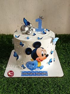 a mickey mouse cake with blue butterflies on it