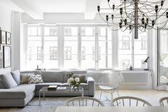 a living room filled with furniture and a chandelier