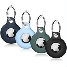 four key chains with an apple logo on one side and two different colors on the other