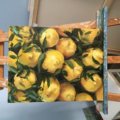 an oil painting of lemons on a easel