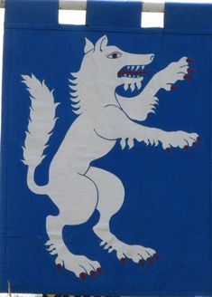 a blue and white sign with an image of a wolf on it's back