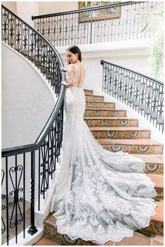 a woman in a wedding dress standing on some stairs