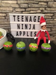 an elf is sitting next to some apples