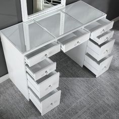 a white desk with drawers and a mirror