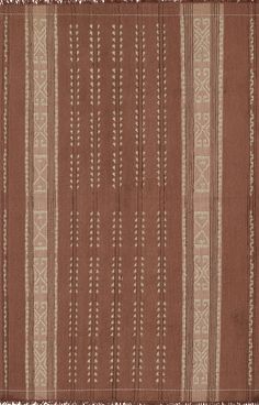 a brown and white striped rug with fringes