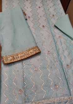 Item Overview ATHARVA Hand Embroidered Salwar Kameez in Blue w/Thread Jaal/ Elegant Hand Work/Gota Patti Border Dupatta/Customized Stitching/Wedding Dno. CH1249 Fabric:  * Shirt Chanderi 2.5 Mts, Blue Jaal Embroidery  * Dupatta: Pure Chiffon Chinnon Dupatta with Gota Patti work 2.5 Mts. * Bottom Santoon Silk 2.5 Mts. Excusive Hand Embroidered Party Wear Punjabi Suit. 🌷CUSTOMIZATION (No Extra Charges) * Fabrics Customization: Designs Can be made in different Fabrics. *Color Customization: Design Traditional Shantoon Straight Kurta With Dabka Work, Traditional Light Blue Zari Work Dresses, Straight Kurta With Mirror Work In Shantoon, Blue Anarkali Embroidered Sharara, Blue Traditional Wear With Dabka Work For Wedding, Fitted Gota Work Kurta For Wedding, Blue Embroidered Anarkali Set For Festive Occasions, Wedding Kurta With Dori Work For Diwali, Festive Blue Embroidered Anarkali Set