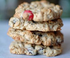 three oatmeal cookies stacked on top of each other with a cherry in the middle