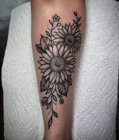 a black and white flower tattoo on the leg