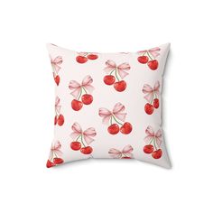 a pink pillow with cherries on it