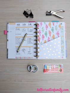 the contents of a planner spread out on a wooden table with scissors and other items