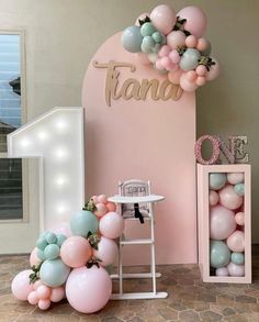 a room decorated with balloons and decorations for a baby's first birthday or party