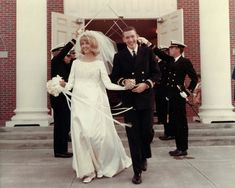 a bride and groom walking down the aisle after their wedding ceremony in an old photo