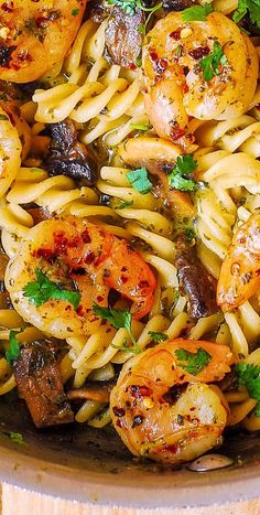 pasta with shrimp, mushrooms and parsley in a pan