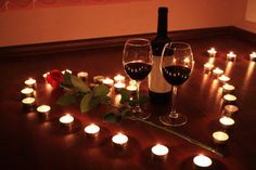 wine glasses and candles are arranged on the floor