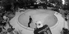 black and white photograph of people at an outdoor skate park