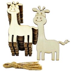 two wooden giraffes standing next to stacks of coins with a string attached