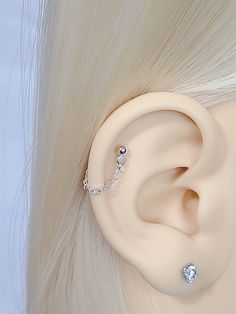 a close up view of a fake ear with chains attached to the middle part of it