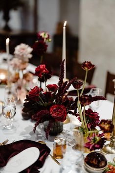 the table is set with flowers and candles