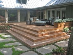 a wooden deck in front of a house