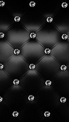 black and white photograph of diamond studded upholstered leather wall with diamonds on it