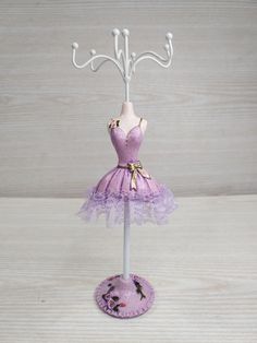 a purple dress on a mannequin stand