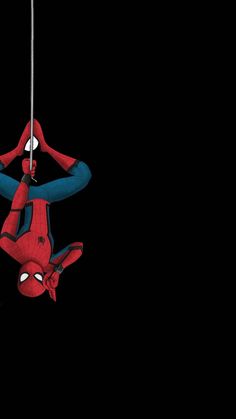 a spider man hanging upside down on a rope with his hands in the air,