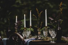 the table is set with candles and place settings