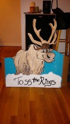 a cardboard box with an image of a moose and the words to toss the rings on it