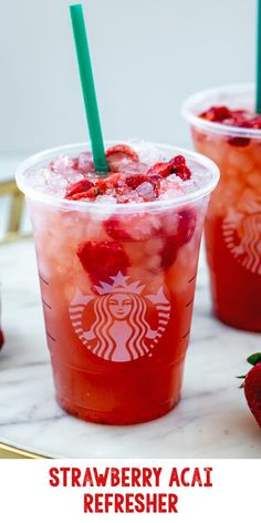 strawberry acai refresher in plastic cups with strawberries on the side and text overlay