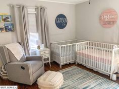 a baby's room with two cribs, a chair and a rug