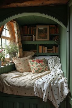 a window seat with pillows and blankets on it