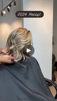 a woman getting her hair cut in a salon